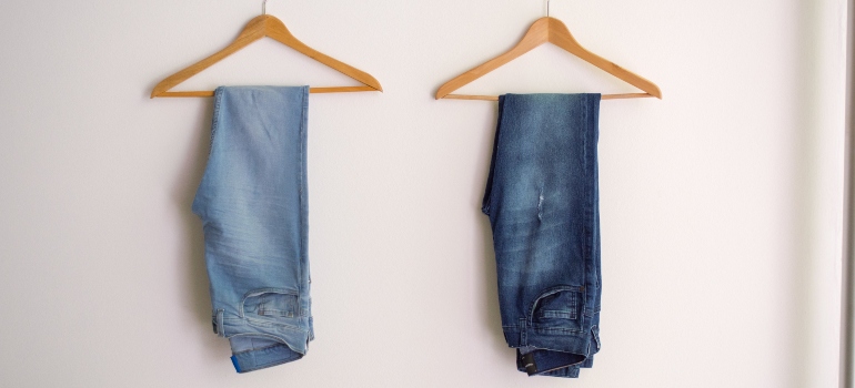 Two pairs of jeans on hangers