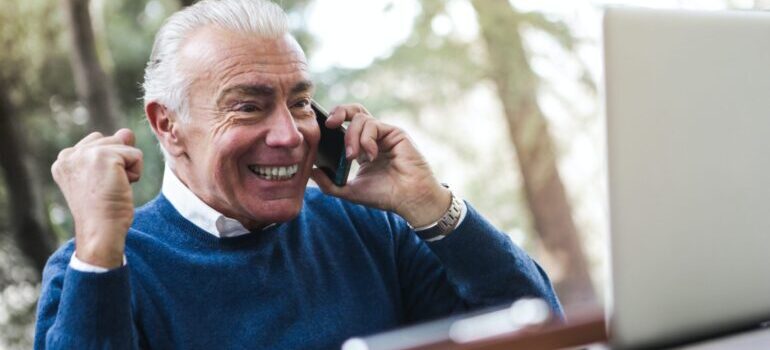 Man smiling and talking on the phone