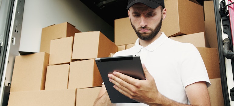 a mover looking at a notebook