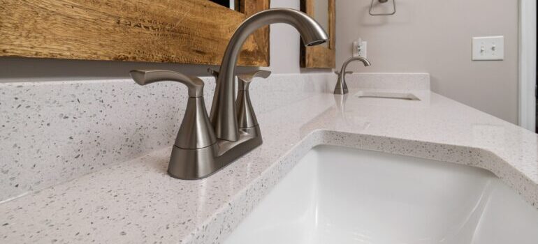 Stainless steel faucets on the speckled marble sink