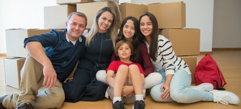 family sitting in front of boxes