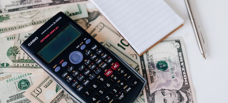 a calculator and dollar bills