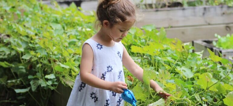A little girl starting a garden in a new backyard