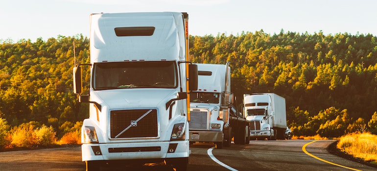 three trucks on the road