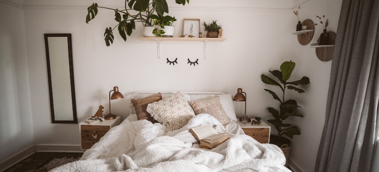 Plants hanging on walls in a bedroom used as home decor hacks to create a cozy bedroom