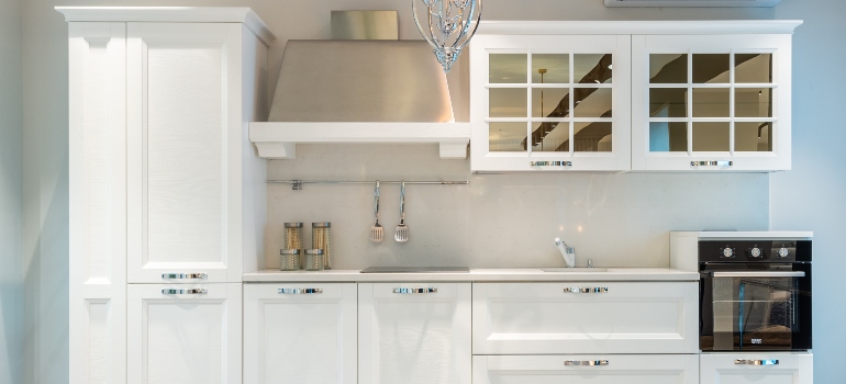 A kitchen with white cupboards
