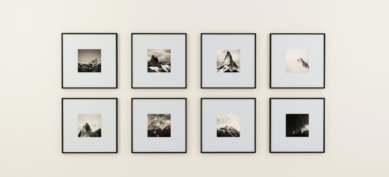 Eight paintings on a white wall