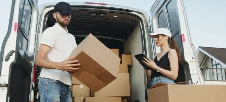 Two movers checking the moving boxes