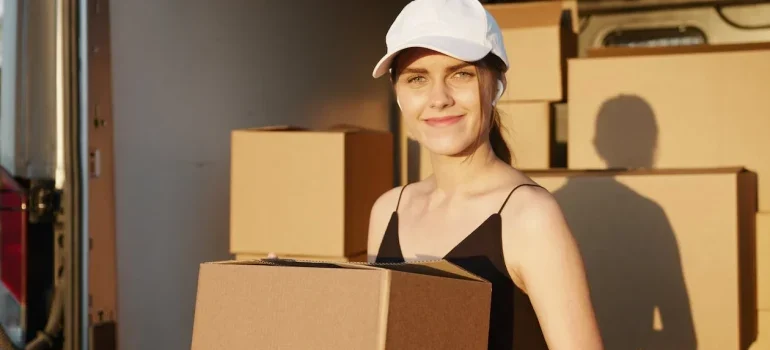 A smiling mover holding a box
