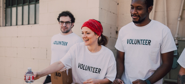 Two men and a woman volunteering