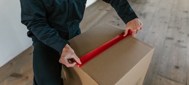 a mover from best cross country movers Canton measuring a box