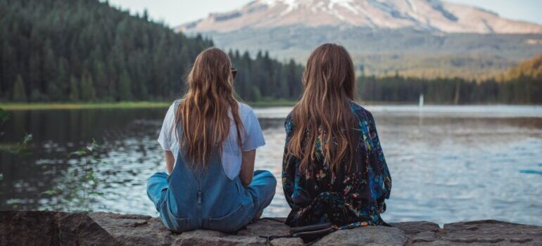 Two girls looking at a lake after moving from California to Oregon