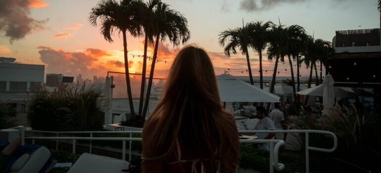 Woman looking at the sunset in South Beach after moving from Houston to Miami