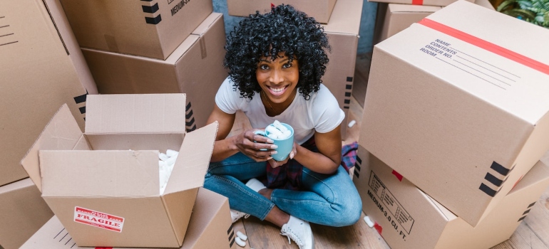 a woman drinking coffee and thinking which moving team she should choose