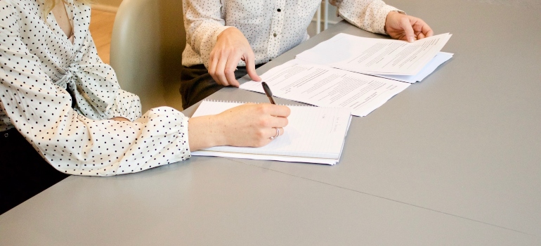 woman signing a document