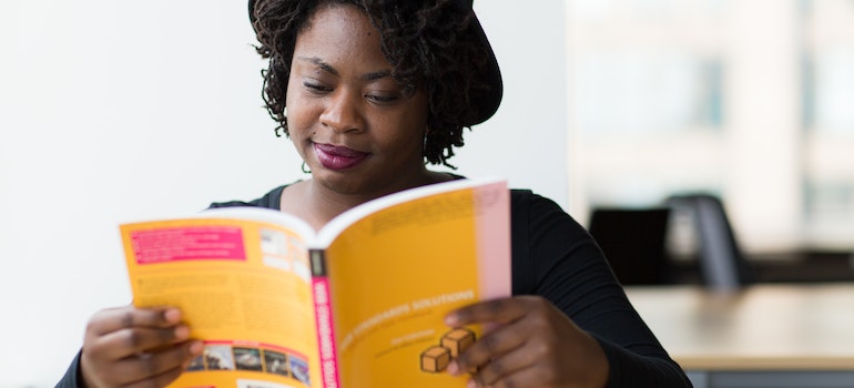 A student reading a yellow book