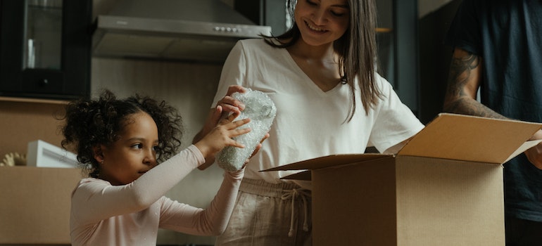 Two people packing a box