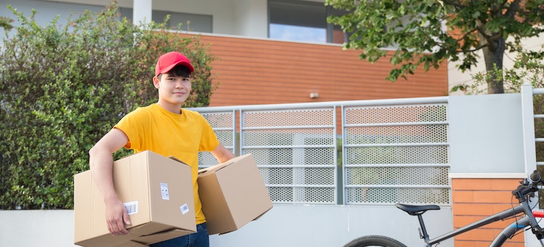 a mover carrying 2 boxes