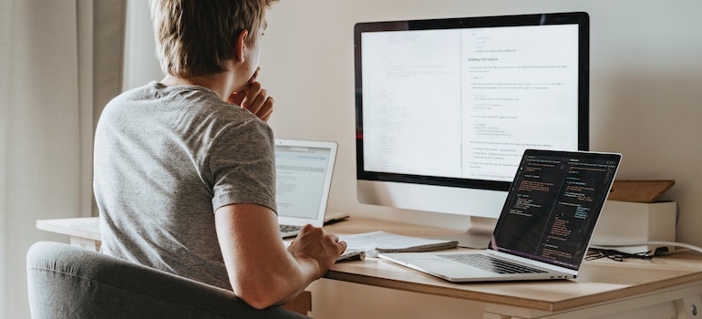 man on a computer, researching moving from Atlanta to Jacksonville