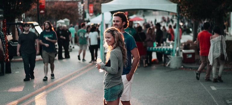 A couple standing in the middle of the street at a county fair in North Little Rock, AR