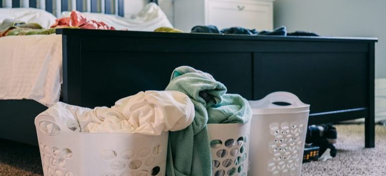 Laundry baskets with clothes inside of them