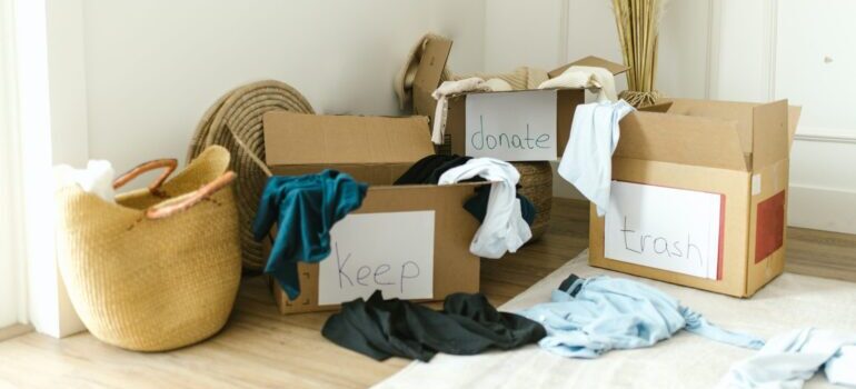 Boxes with clothes to keep, donate and throw away