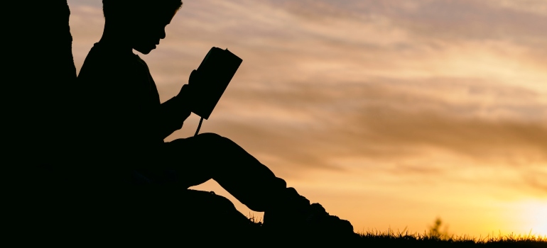 Picture of a child reading a book 
