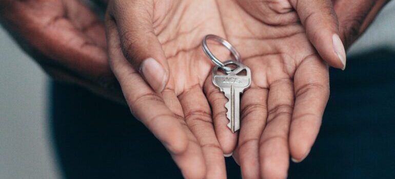 Hands holding a key to a new home