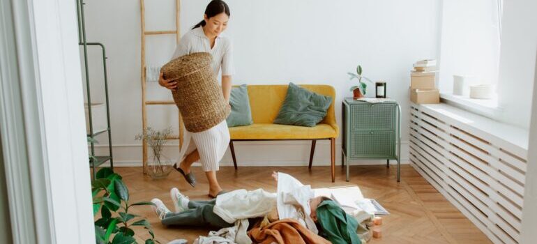 Woman selecting her clothes before utilizing storage services during a cross country move