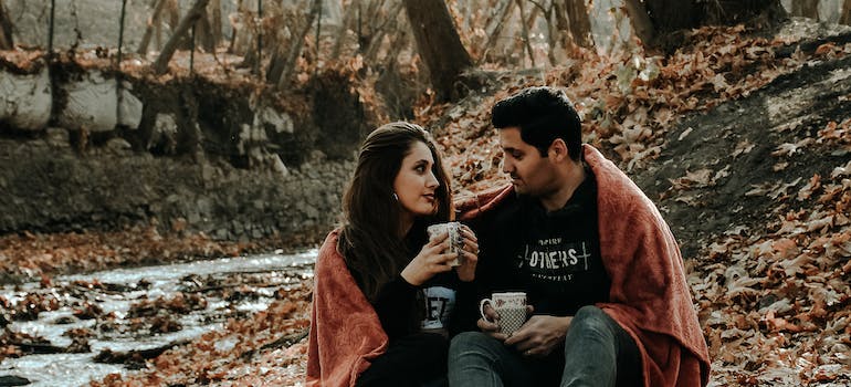 A couple enjoying themselves in fall landscape