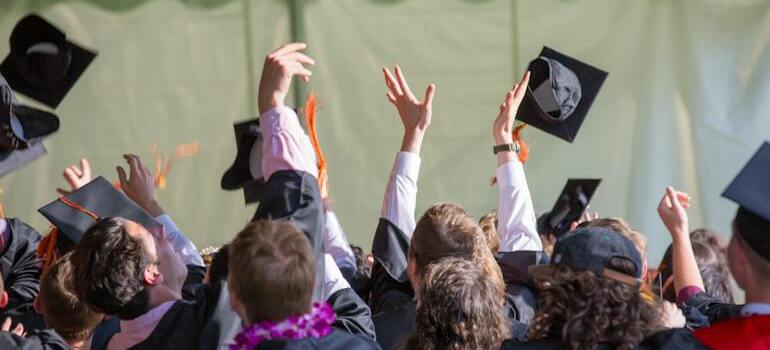 Students throwing their hats on graduation day