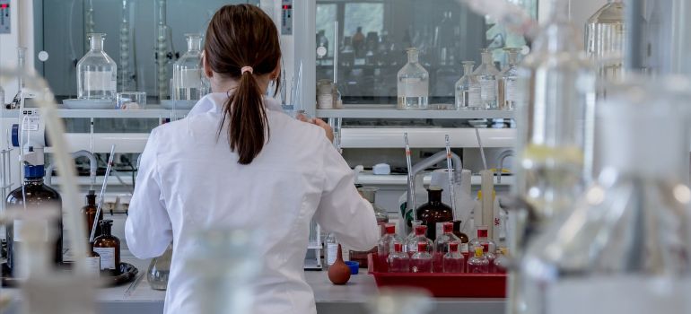 Person in a white coat working in a lab