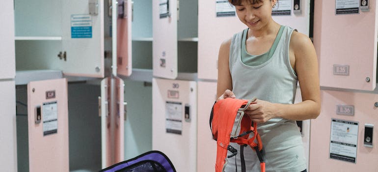 a woman packing sports equipment