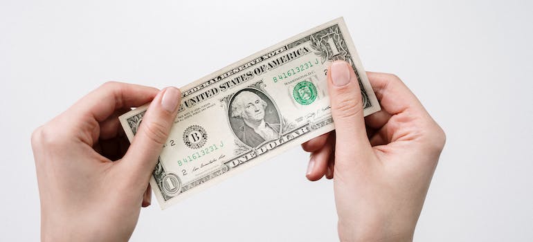 hands holding a paper money