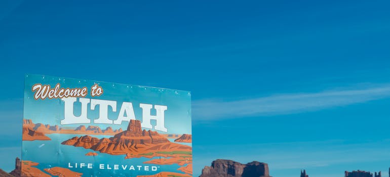 A blue billboard saying "Welcome to Utah"