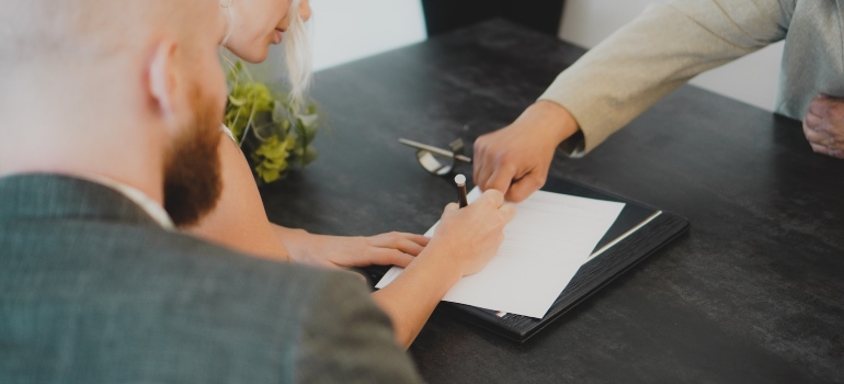 Picture of a person signing a contract 