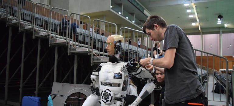 Man assembling a robot.