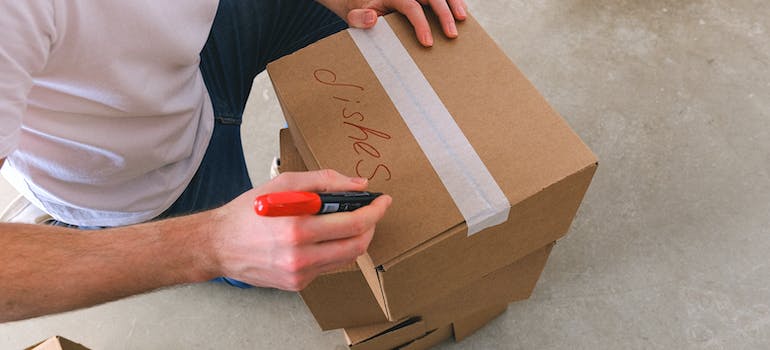 a man writing on a box