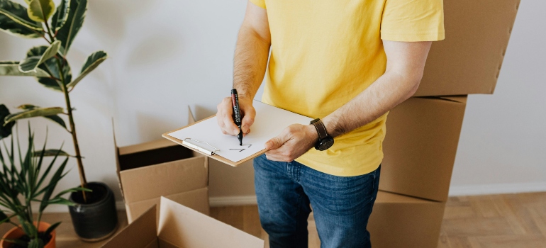 A man organizing his stuff before moving from Austin to New York.