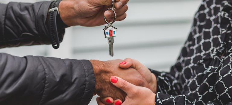 person giving another person a key