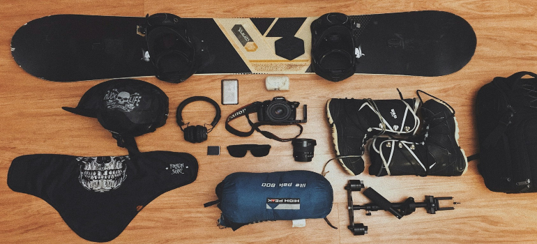 A picture of snowboarding gear laid out on the floor.