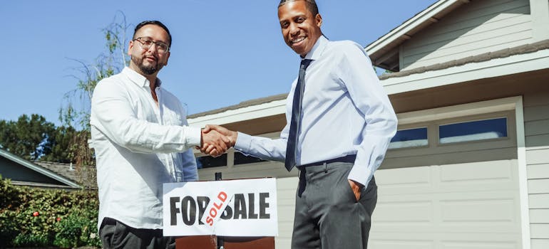 A real estate agent shaking hands with his client