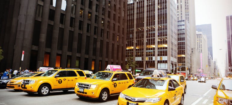 yellow taxi vehicles at the street