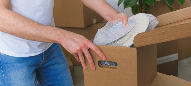 person packing stuff into a box