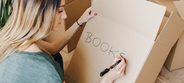 A woman labeling a box