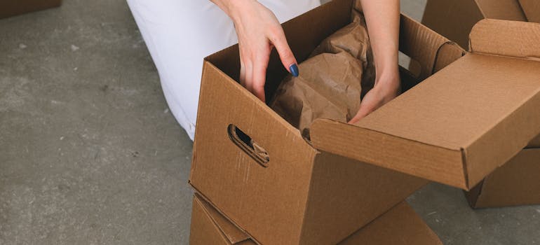 person packing stuff into boxes
