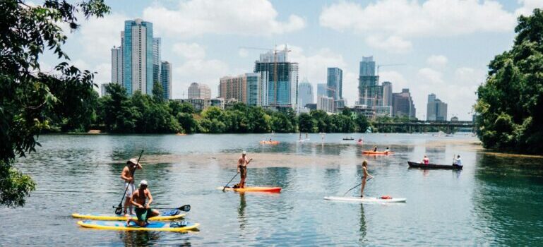 People riding paddle boards on a lake in Austin
